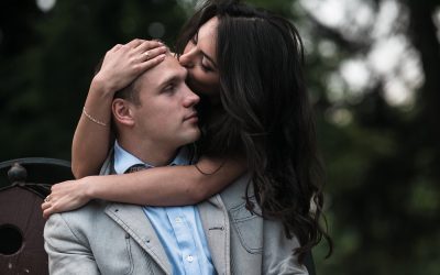 young woman kissing her boyfriend s forehead